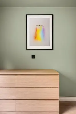 a framed picture on a wall above a dresser at Odda Living - 3BR & 1BR - A3 in Tokheim