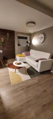 a living room with a white couch and a table at Cozy and warm just like at home, Free P, Big terrace in Langevåg