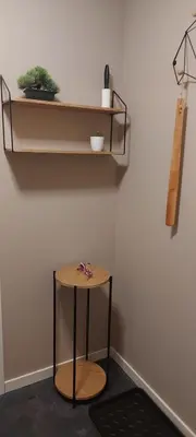 a shelf on a wall with a small stool at Cozy and warm just like at home, Free P, Big terrace in Langevåg