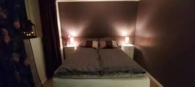 a small bedroom with a bed with two candles at Cozy and warm just like at home, Free P, Big terrace in Langevåg
