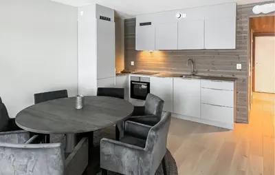 a kitchen with a table and chairs and a sink at Awesome Apartment In Geilo With Sauna in Geilo