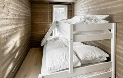 a bunk bed in a room with wooden walls at Awesome Apartment In Geilo With Sauna in Geilo
