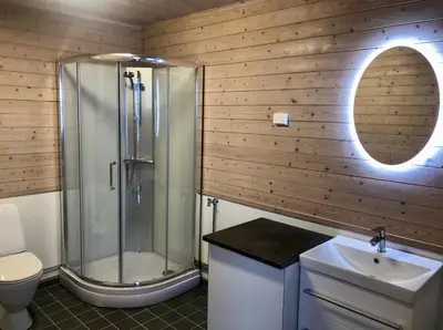 a bathroom with a shower and a toilet and a sink at Birdbox Reksta in Florø