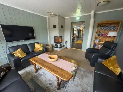 a living room with couches and a table and a tv at Øyer Fjellstugu in Øyer