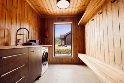 a kitchen with a washing machine and a window at The View - Hodlekve in Sogndal
