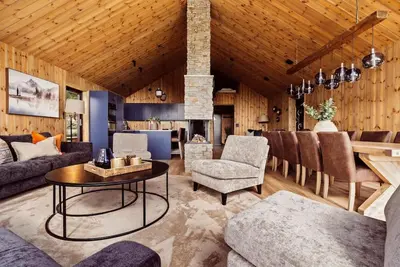 a living room with a couch and a table at The View - Hodlekve in Sogndal