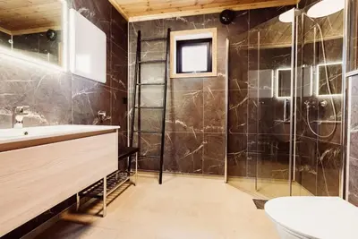 a bathroom with a shower and a toilet and a sink at The View - Hodlekve in Sogndal