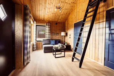 a living room with a staircase and a couch at The View - Hodlekve in Sogndal
