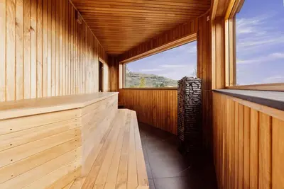 a sauna with a large window in a wooden room at The View - Hodlekve in Sogndal