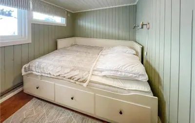 a small bedroom with a bed in a corner at Awesome Home In Trysil With Wifi in Trysil
