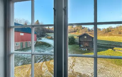 an open window with a view of a barn at 4 Bedroom Cozy Home In Svorkmo in Brattli