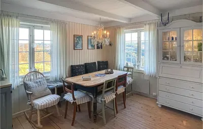 a kitchen with a dining room table and chairs at 4 Bedroom Cozy Home In Svorkmo in Brattli