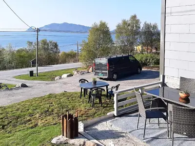 a van parked on the side of a house with a table at 6 person holiday home in Åram-By Traum in Sandvik