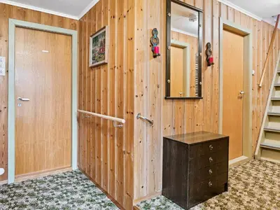 a room with a wooden wall with a door and a staircase at 6 person holiday home in Åram-By Traum in Sandvik