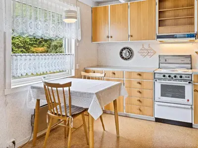a kitchen with a table and chairs and a window at 6 person holiday home in Åram-By Traum in Sandvik