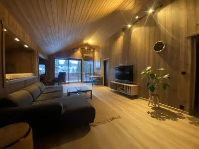 a living room with a couch and a tv at Newly renovated apartment with a central location in Geilo