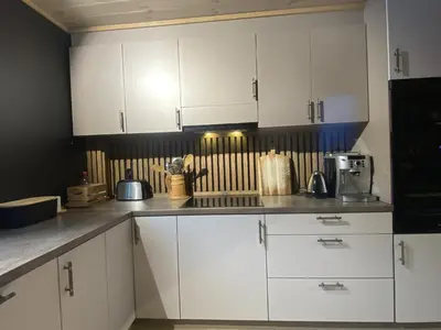 a kitchen with white cabinets and a counter top at Newly renovated apartment with a central location in Geilo