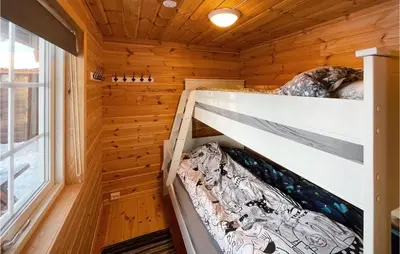 a bedroom in a log cabin with a bunk bed at 5 Bedroom Pet Friendly Home In Jordet in Jordet