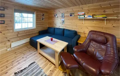 a living room with a blue couch and a table at 5 Bedroom Pet Friendly Home In Jordet in Jordet