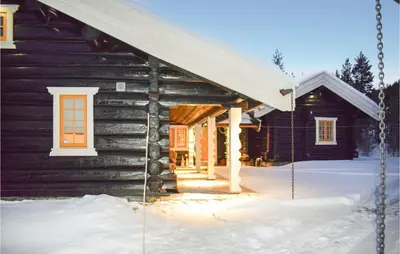a log cabin with a porch in the snow at Awesome Home In Hemsedal With Sauna in Hemsedal