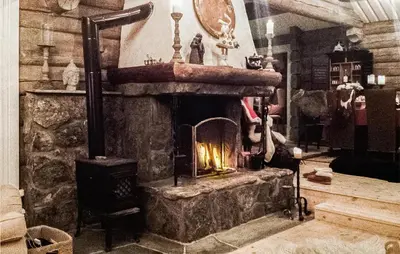 a stone fireplace in a room with a stove at Awesome Home In Hemsedal With Sauna in Hemsedal