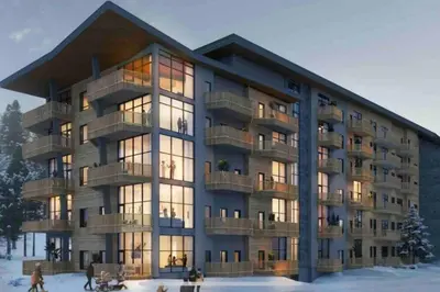 a large building with people walking in the snow at Topp studio leilighet Alpine Lodge in Trysil