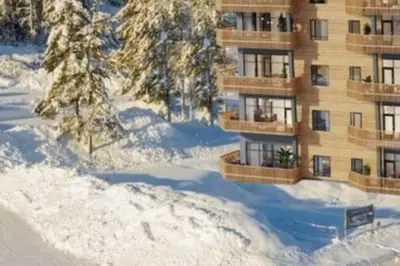 a building with snow in front of it at Topp studio leilighet Alpine Lodge in Trysil