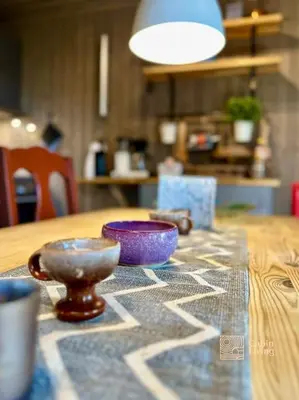 a wooden table with two bowls on top of it at Cozy apartment ski in out, BBQ & Wifi Sjusjøen in Sjusjøen