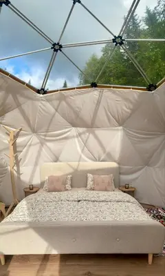 a bedroom with a bed in a tent at Dome Glamping with shared bathroom in Lillehammer