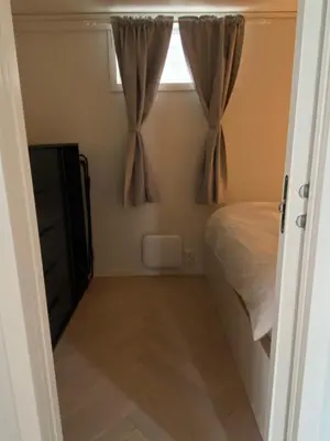 a bedroom with a bed and a window at Entire renovated apartment from 1780 with Kitchen, Bath, Bedroom, and Living Room in Skuteviken in Bergen