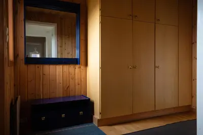 a room with wooden cabinets and a mirror at Osloveien 6 in Røros