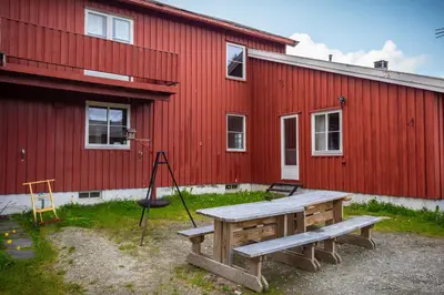 a picnic table in front of a red building at Osloveien 6 in Røros