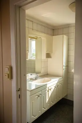 a white kitchen with a sink and a refrigerator at Osloveien 6 in Røros