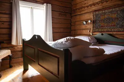 a bedroom with a bed in a room with a window at Bergmannsgata 3 in Røros