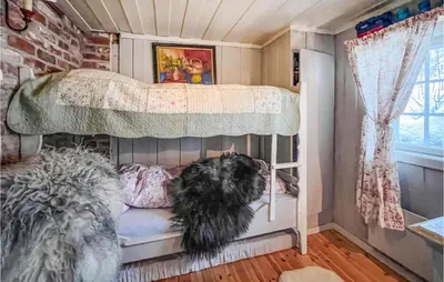 a dog sitting on a bunk bed in a room at 4 Bedroom Nice Home In Vang I Valdres in Vang I Valdres