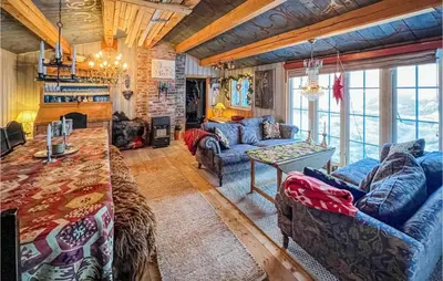 a living room with blue couches and a fireplace at 4 Bedroom Nice Home In Vang I Valdres in Vang I Valdres
