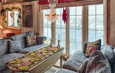 a living room with two couches and a chandelier at 4 Bedroom Nice Home In Vang I Valdres in Vang I Valdres