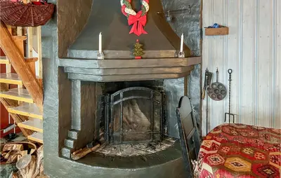 a fireplace with a red bow on top of it at 4 Bedroom Nice Home In Vang I Valdres in Vang I Valdres