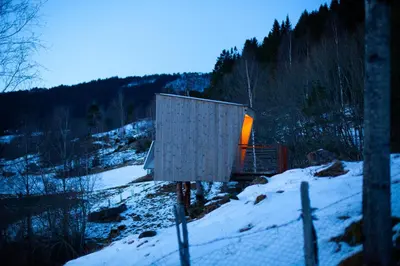 a box sitting on top of a snow covered hill at Engeset Trehytter in Vereide
