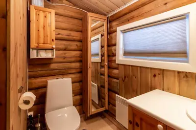a bathroom with a toilet and a sink and a window at Trysilfjellet sør 318 in Trysil