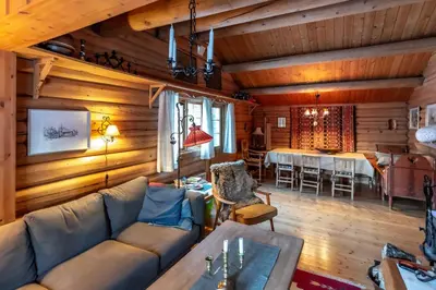a living room with a couch and a dining room at Trysilfjellet sør 318 in Trysil
