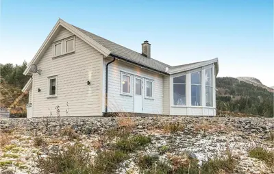 a small house on a rocky hill with a house at Lovely Home In Stadlandet in Stadlandet
