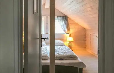 a bedroom with a bed in a attic at Lovely Home In Stadlandet in Stadlandet
