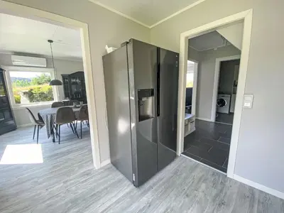a large stainless steel refrigerator in a living room at Holiday Home Sjøtun by Interhome in Hyllestad
