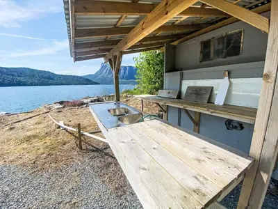 a kitchen with a table and a sink on a boat at Holiday Home Sjøtun by Interhome in Hyllestad