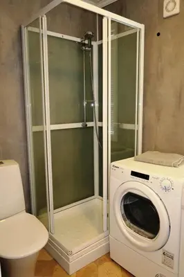 a washing machine and a washer in a bathroom at Holiday Home Kalavåg by Interhome in Kalavåg