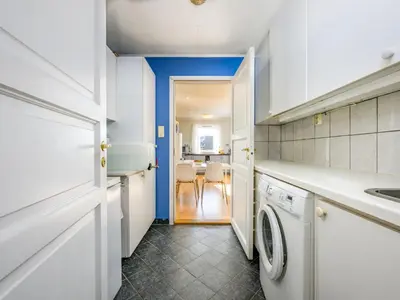 a kitchen with a washing machine and a dining room at Chalet Seievika by Interhome in Brekke