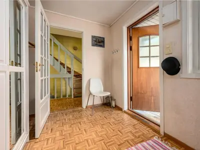 a hallway with a chair and stairs in a house at Chalet Seievika by Interhome in Brekke