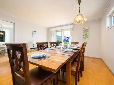 a dining room with a wooden table and chairs at Chalet Seievika by Interhome in Brekke