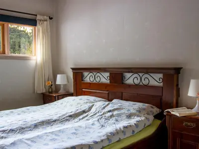 a bedroom with a bed and two lamps and a window at Chalet Heggland Huset by Interhome in Heggland